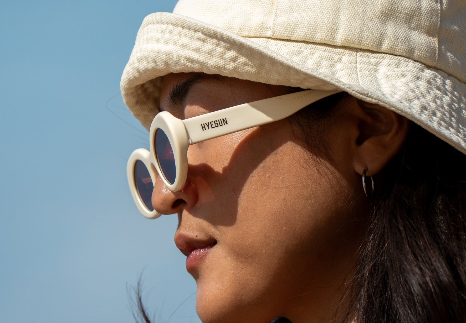 Woman wearing Hyesun low nose bridge sunglasses for UV eye protection in Australia